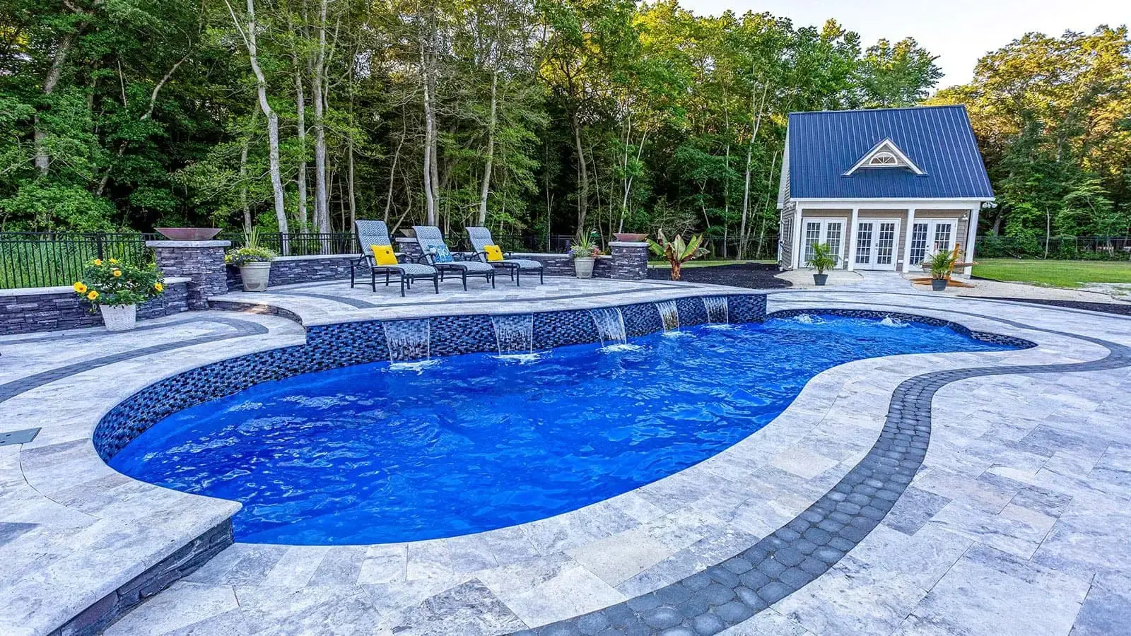 Backyard pool with lounge chairs and cabana.